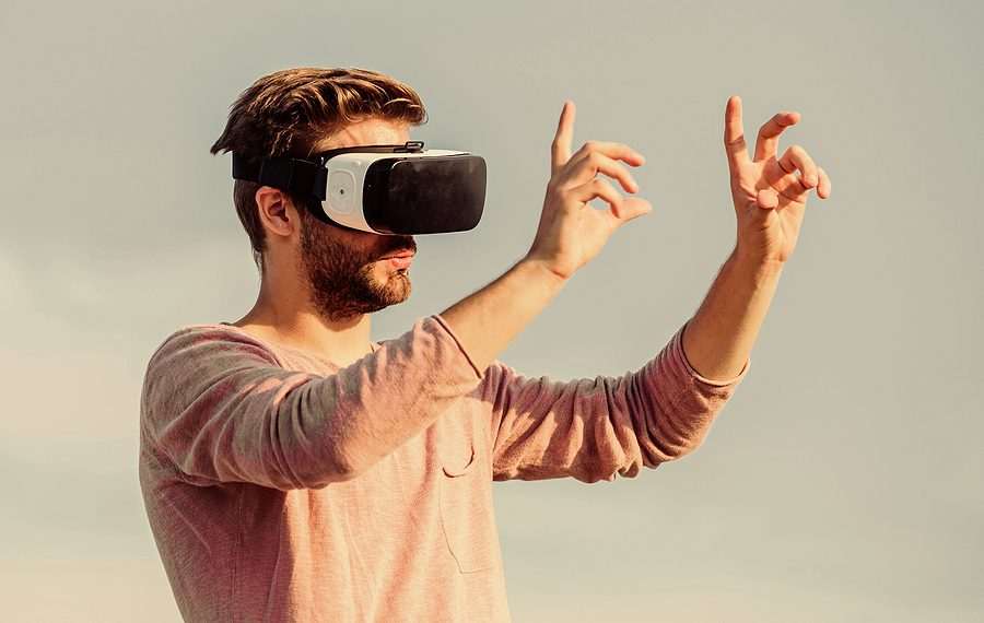 Designer or engineer. Designing 3d objects. Educational futuristic program. Cyber space. Virtual reality. Game online. Man with wireless VR glasses headset. Augmented reality. Virtual reality goggles