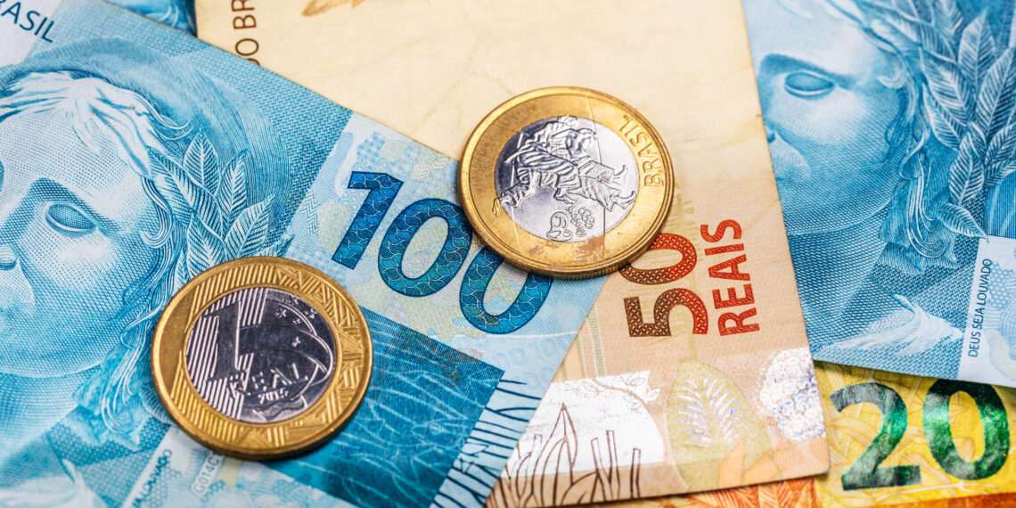 A top view of Brazilian real banknotes and coins