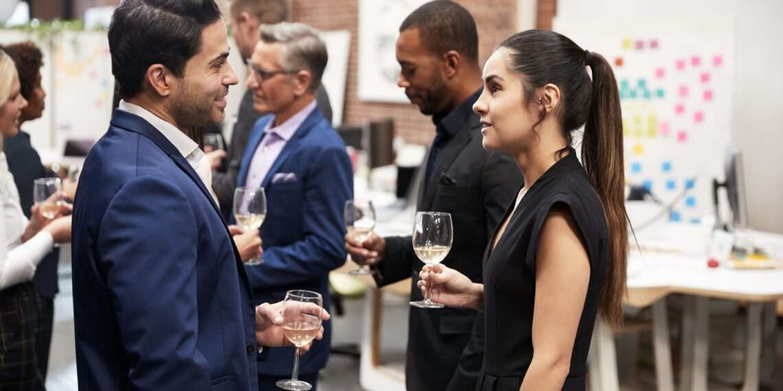 Business Team Socializing At After Works Drinks In Modern Office