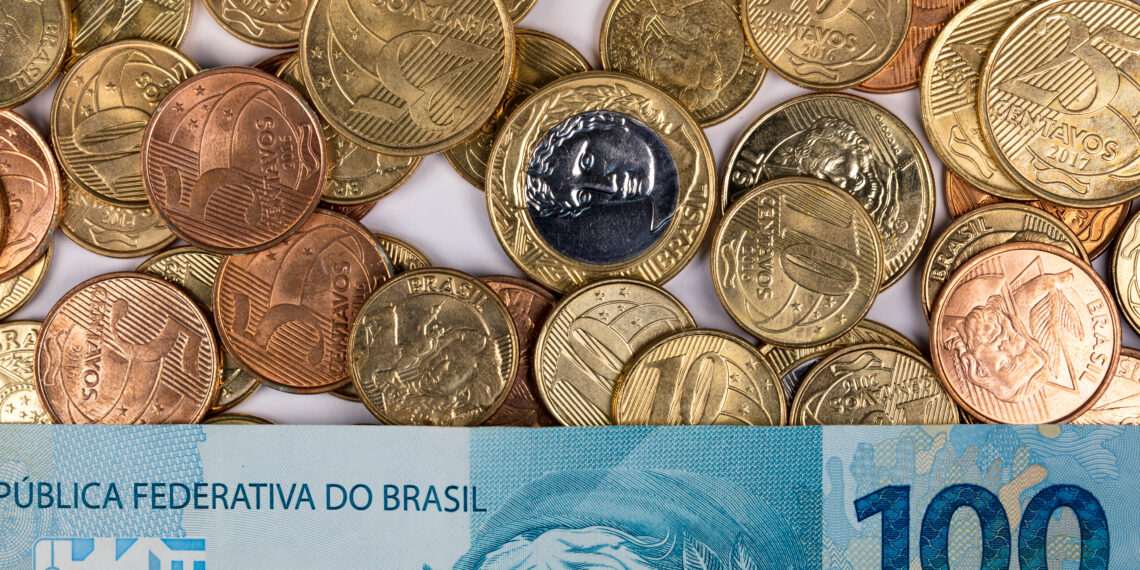 A closeup shot of Brazilian reals and coins - finance concept